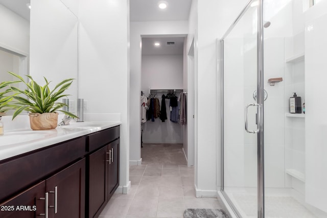 bathroom featuring vanity, an enclosed shower, and tile patterned flooring