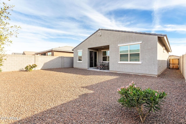 back of house with a patio