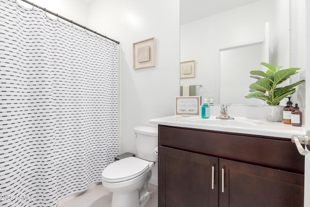 bathroom featuring vanity, toilet, and a shower with shower curtain