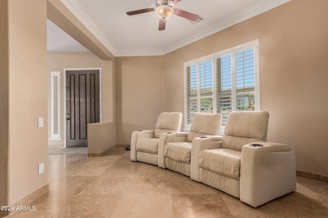 home theater room with crown molding and ceiling fan