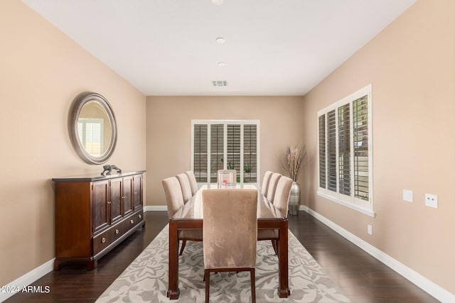 dining area featuring a healthy amount of sunlight and dark hardwood / wood-style flooring