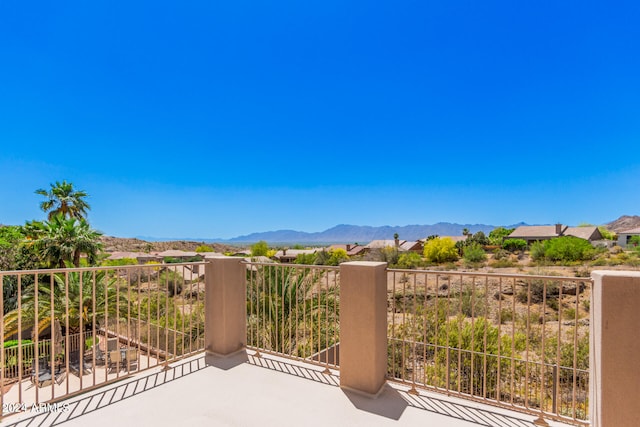 view of patio featuring a balcony and a mountain view