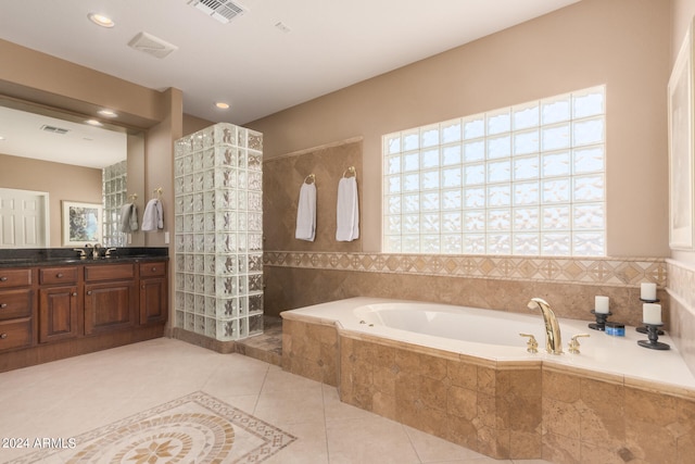 bathroom with vanity, tile patterned floors, a healthy amount of sunlight, and separate shower and tub