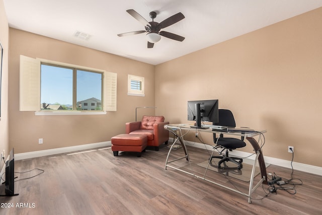 home office with wood-type flooring and ceiling fan