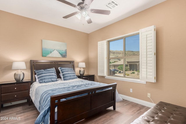 bedroom with ceiling fan and hardwood / wood-style floors