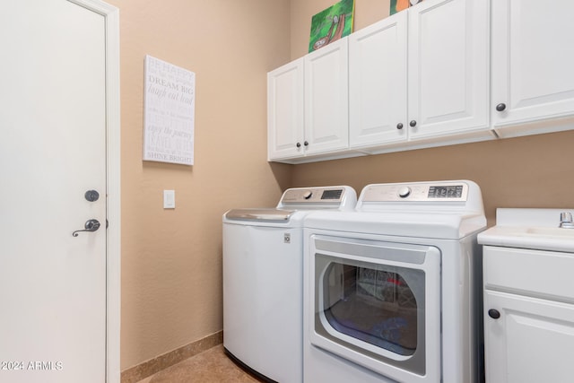 clothes washing area with separate washer and dryer, cabinets, and light tile patterned floors