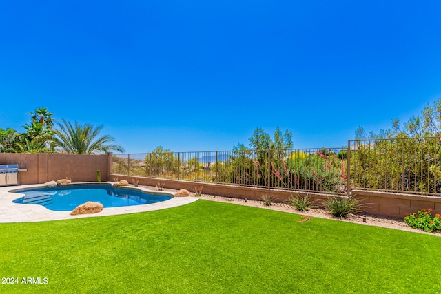 view of pool featuring a lawn