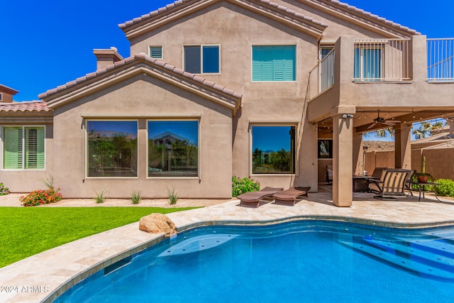 back of house with ceiling fan and a patio