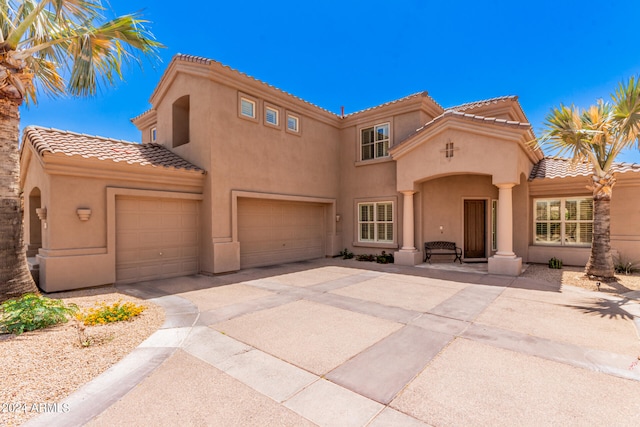 mediterranean / spanish-style home featuring a garage