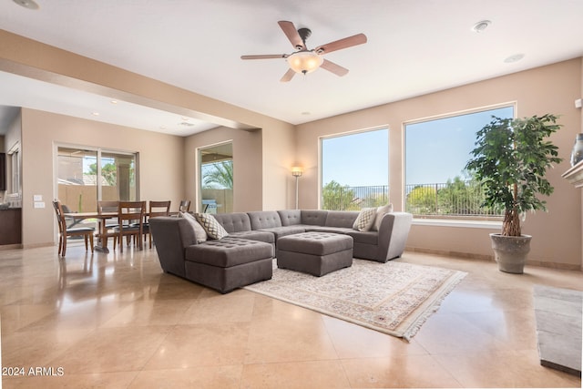 tiled living room with ceiling fan