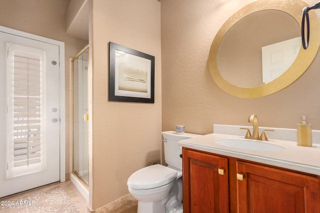 bathroom featuring vanity, an enclosed shower, and toilet