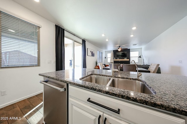1713 W Cottonwood Ln, Phoenix, AZ 85045 - kitchen featuring dark stone counters, dark wood-style floors, white cabinetry, a ceiling fan, and dishwasher