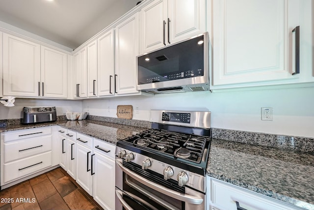 1713 W Cottonwood Ln, Phoenix, AZ 85045 - kitchen with dark stone counters, white cabinetry, stainless steel appliances, and wood finish floors