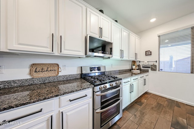 1713 W Cottonwood Ln, Phoenix, AZ 85045 - kitchen with dark wood-style floors, dark stone countertops, stainless steel appliances, white cabinetry, and recessed lighting