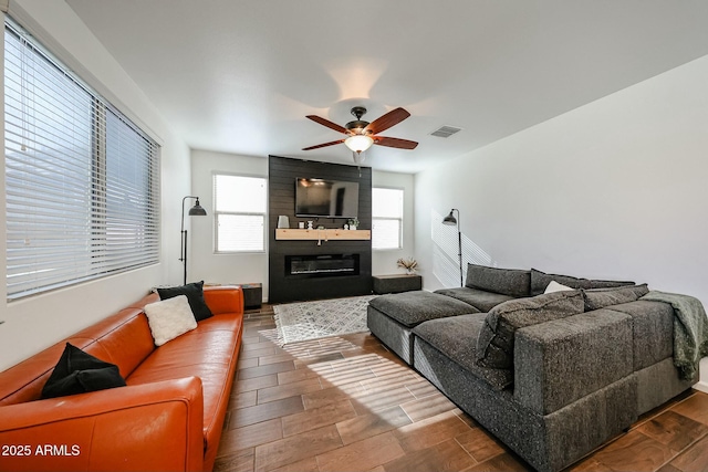 1713 W Cottonwood Ln, Phoenix, AZ 85045 - living room featuring wood finished floors, visible vents, a fireplace, and ceiling fan