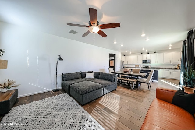 1713 W Cottonwood Ln, Phoenix, AZ 85045 - living area featuring visible vents, baseboards, ceiling fan, light wood-type flooring, and recessed lighting