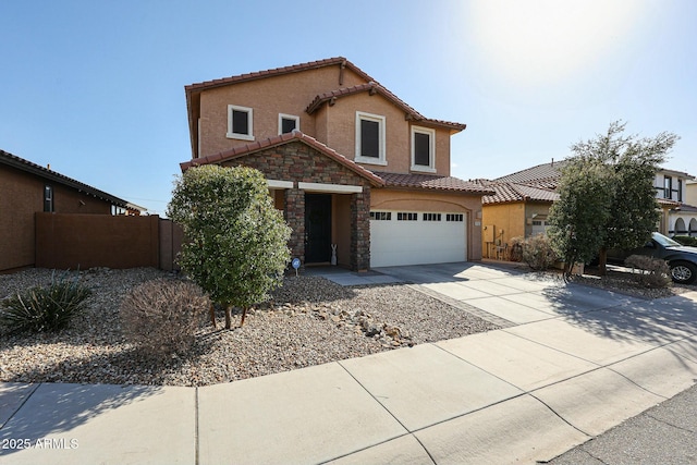 view of front facade with fence, a tile roof, stone siding, concrete driveway, and stucco siding