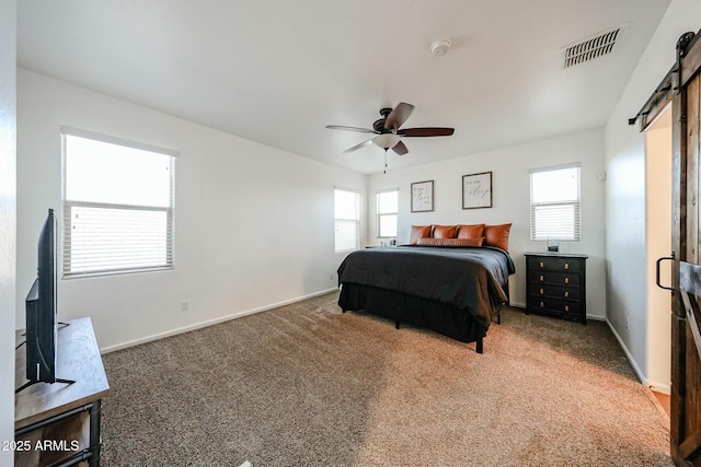 1713 W Cottonwood Ln, Phoenix, AZ 85045 - bedroom featuring visible vents, a barn door, carpet flooring, ceiling fan, and baseboards