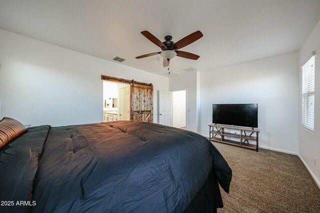 1713 W Cottonwood Ln, Phoenix, AZ 85045 - carpeted bedroom with a barn door, visible vents, ceiling fan, and baseboards