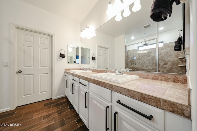 1713 W Cottonwood Ln, Phoenix, AZ 85045 - full bath featuring tiled shower, a sink, visible vents, and wood tiled floor
