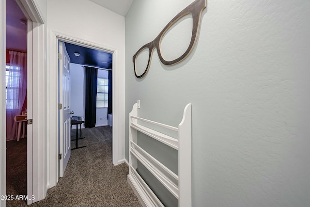 1713 W Cottonwood Ln, Phoenix, AZ 85045 - corridor featuring dark colored carpet, a textured wall, and an upstairs landing