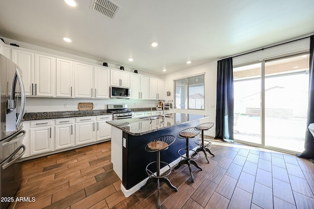 1713 W Cottonwood Ln, Phoenix, AZ 85045 - kitchen with stainless steel appliances, visible vents, a sink, and white cabinetry