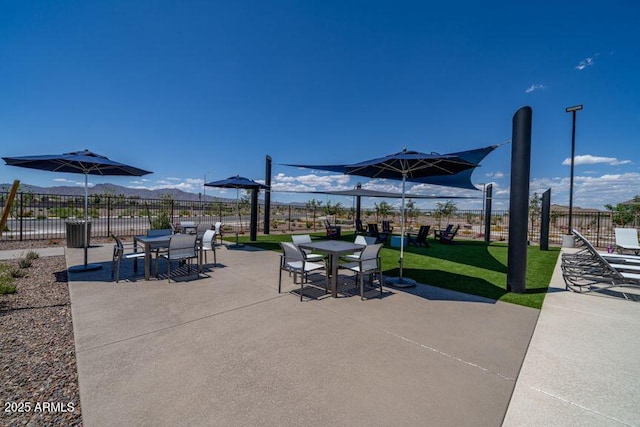 view of patio with a mountain view and outdoor dining space