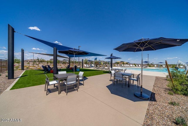 view of patio / terrace with a community pool and outdoor dining area