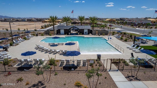 community pool featuring fence and a patio area