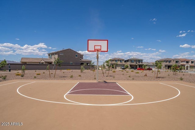 view of basketball court with community basketball court, fence, and a residential view