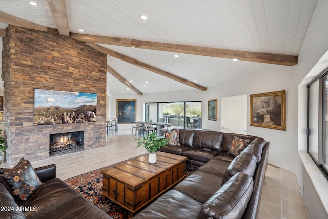 tiled living room with vaulted ceiling with beams, a stone fireplace, and wood ceiling