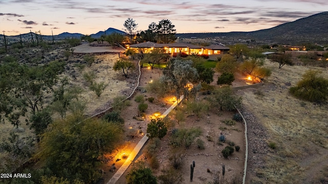 aerial view at dusk featuring a mountain view