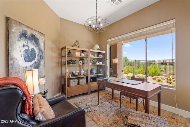 office space featuring light hardwood / wood-style flooring and a chandelier