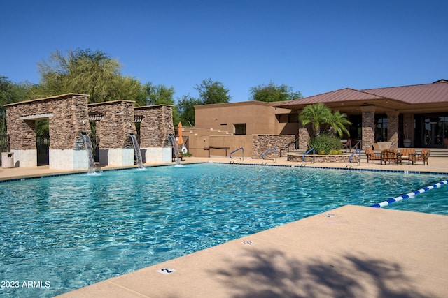 view of swimming pool with a patio area and pool water feature