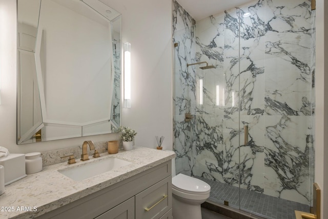 full bath with a marble finish shower, toilet, and vanity
