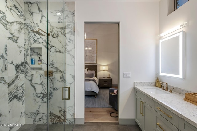 bathroom with a marble finish shower, ensuite bath, and vanity