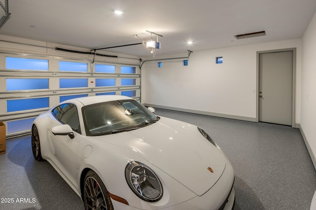 garage with baseboards, a garage door opener, and recessed lighting