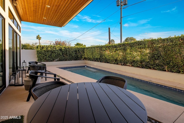 view of swimming pool featuring a jacuzzi, outdoor dining area, and a patio area
