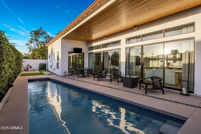 back of house featuring stucco siding, a fenced backyard, and a patio area