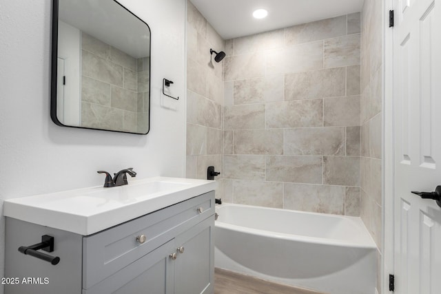 bathroom featuring vanity and tiled shower / bath combo