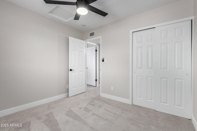 unfurnished bedroom with ceiling fan, a closet, and light carpet