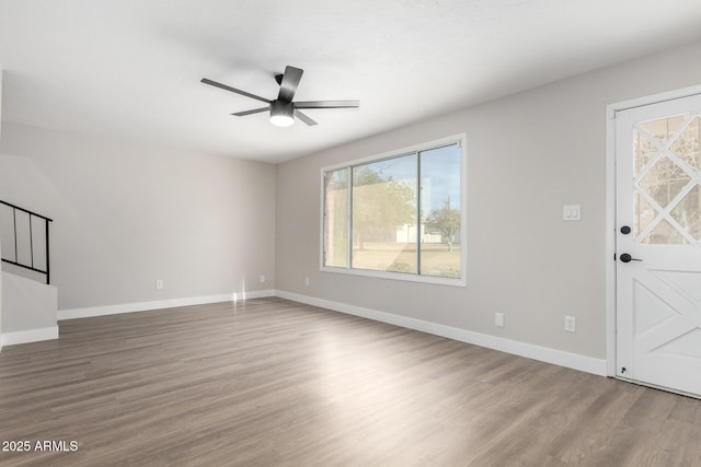 unfurnished living room with hardwood / wood-style flooring and ceiling fan