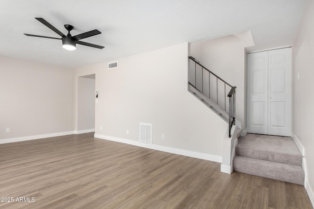 unfurnished living room with ceiling fan and hardwood / wood-style floors