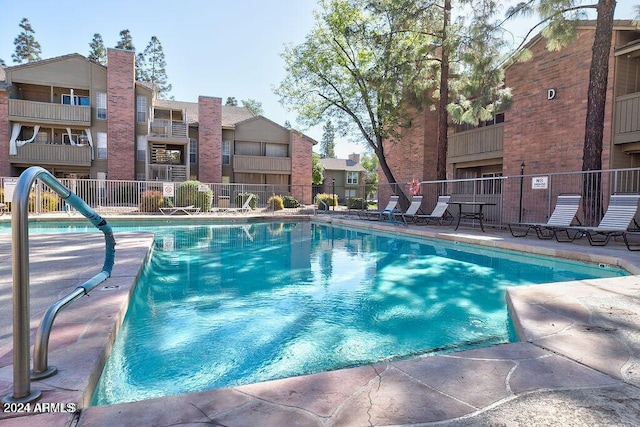 community pool featuring fence