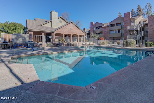 pool featuring a patio and fence