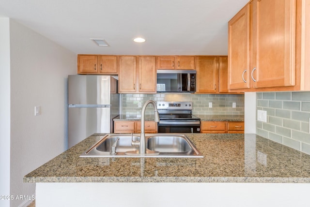 kitchen with light stone counters, visible vents, a sink, appliances with stainless steel finishes, and backsplash