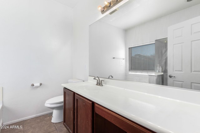 bathroom with tile patterned flooring, vanity, and toilet