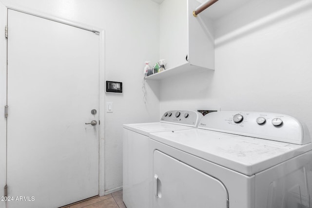 laundry room with separate washer and dryer and light tile patterned floors