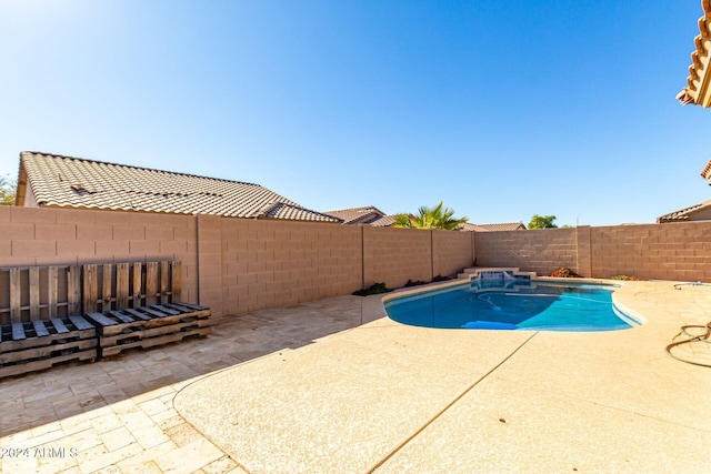 view of swimming pool with a patio area