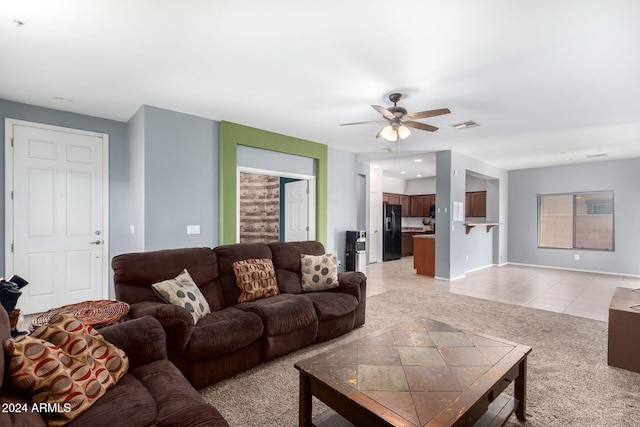 living room featuring light tile patterned floors and ceiling fan